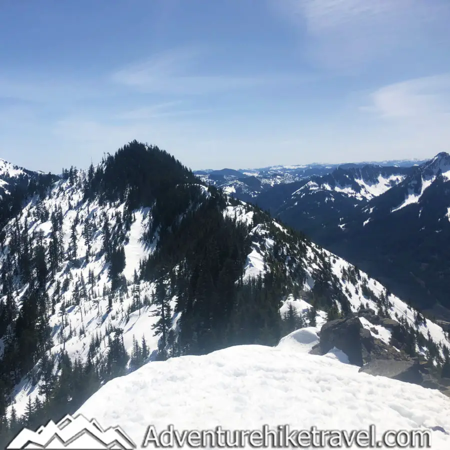 Mailbox Peak On a clear blue bird day you are privy to a gorgeous 360 view of mountains every direction you turn. Mt Rainier is on full display but you can also see Glacier Peak, Bandera Mountain, Mount Defiance, Granite Mountain, and if you squint maybe even Mt. Pilchuck in the distance.A bit to the east you can see Russian Butte, Kaleetan Peak, Dirtybox Peak and Dirty Harry’s Peak, in addition to many other mountains in the Middle Fork Snoqualmie River Valley. You can see the vibrant teal waters of Rattlesnake Lake with Rattlesnake ledge above it. While looking that direction you can also make out Mt. Si and Mt. Teneriffe.