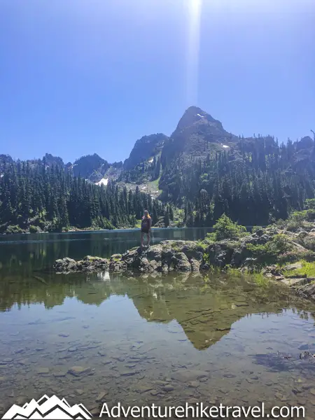 Backpacking Upper Lena Lake - Olympic National Park in Washington State. Upper Lena Lake is a gorgeous alpine lake located in Olympic National Park. This beautiful picturesque lake makes for an excellent summer backpacking destination for adventurous souls. The lake is crystal clear with vivid hues of blue and green. You can see every rock and even several large rainbow trout swimming. This strenuous 14-mile hike with 3,943 feet of elevation gain is not for the beginner hiker. But for those who wish to go on a journey and see some of Olympic National Park's untouched beauty, this is the backpacking destination for you.