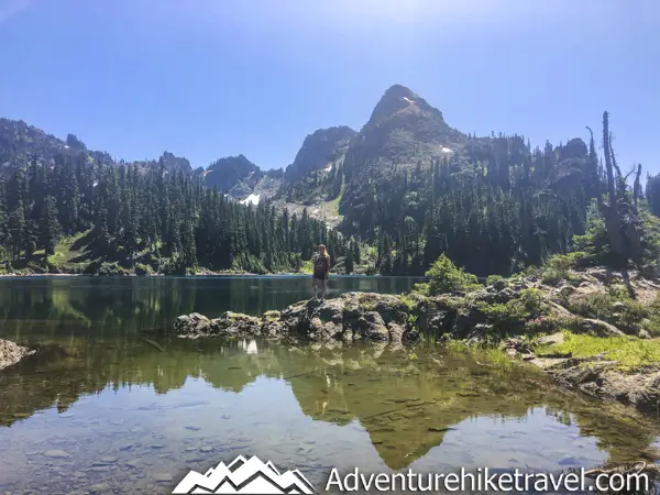 Backpacking Upper Lena Lake - Olympic National Park in Washington State. Upper Lena Lake is a gorgeous alpine lake located in Olympic National Park. This beautiful picturesque lake makes for an excellent summer backpacking destination for adventurous souls. The lake is crystal clear with vivid hues of blue and green. You can see every rock and even several large rainbow trout swimming. This strenuous 14-mile hike with 3,943 feet of elevation gain is not for the beginner hiker. But for those who wish to go on a journey and see some of Olympic National Park's untouched beauty, this is the backpacking destination for you.