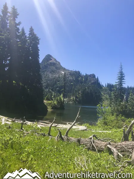 Backpacking Upper Lena Lake - Olympic National Park in Washington State. Upper Lena Lake is a gorgeous alpine lake located in Olympic National Park. This beautiful picturesque lake makes for an excellent summer backpacking destination for adventurous souls. The lake is crystal clear with vivid hues of blue and green. You can see every rock and even several large rainbow trout swimming. This strenuous 14-mile hike with 3,943 feet of elevation gain is not for the beginner hiker. But for those who wish to go on a journey and see some of Olympic National Park's untouched beauty, this is the backpacking destination for you.