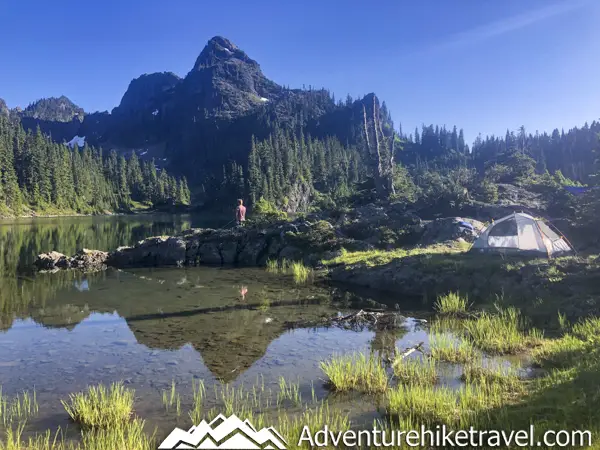 Backpacking Upper Lena Lake - Olympic National Park in Washington State. Upper Lena Lake is a gorgeous alpine lake located in Olympic National Park. This beautiful picturesque lake makes for an excellent summer backpacking destination for adventurous souls. The lake is crystal clear with vivid hues of blue and green. You can see every rock and even several large rainbow trout swimming. This strenuous 14-mile hike with 3,943 feet of elevation gain is not for the beginner hiker. But for those who wish to go on a journey and see some of Olympic National Park's untouched beauty, this is the backpacking destination for you.