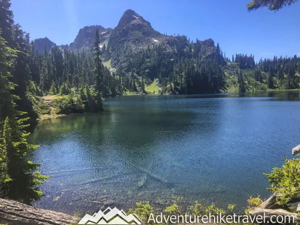 Backpacking Upper Lena Lake - Olympic National Park in Washington State. Upper Lena Lake is a gorgeous alpine lake located in Olympic National Park. This beautiful picturesque lake makes for an excellent summer backpacking destination for adventurous souls. The lake is crystal clear with vivid hues of blue and green. You can see every rock and even several large rainbow trout swimming. This strenuous 14-mile hike with 3,943 feet of elevation gain is not for the beginner hiker. But for those who wish to go on a journey and see some of Olympic National Park's untouched beauty, this is the backpacking destination for you.