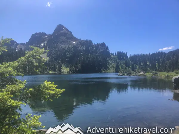 Backpacking Upper Lena Lake - Olympic National Park in Washington State. Upper Lena Lake is a gorgeous alpine lake located in Olympic National Park. This beautiful picturesque lake makes for an excellent summer backpacking destination for adventurous souls. The lake is crystal clear with vivid hues of blue and green. You can see every rock and even several large rainbow trout swimming. This strenuous 14-mile hike with 3,943 feet of elevation gain is not for the beginner hiker. But for those who wish to go on a journey and see some of Olympic National Park's untouched beauty, this is the backpacking destination for you.