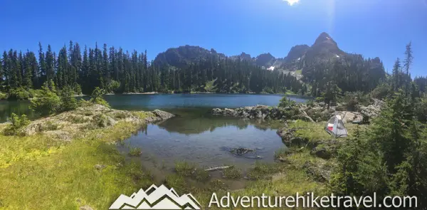 Backpacking Upper Lena Lake - Olympic National Park in Washington State. Upper Lena Lake is a gorgeous alpine lake located in Olympic National Park. This beautiful picturesque lake makes for an excellent summer backpacking destination for adventurous souls. The lake is crystal clear with vivid hues of blue and green. You can see every rock and even several large rainbow trout swimming. This strenuous 14-mile hike with 3,943 feet of elevation gain is not for the beginner hiker. But for those who wish to go on a journey and see some of Olympic National Park's untouched beauty, this is the backpacking destination for you.