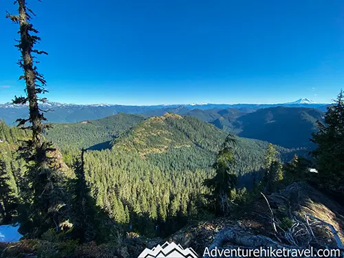 High Rock Lookout – Hiking in Gifford Pinchot National Forest The trail is mostly forested with some gaps through the trees where at times you can see Mt. Rainier directly in front of you poking through the tree canopy. At the 1.3 mile mark, you get your first real good clear opening through the trees. At this rocky viewpoint, you can see the sprawling vista of the valley below and an up-close view of Mt. Adams.