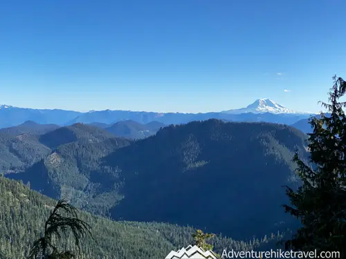 High Rock Lookout – Hiking in Gifford Pinchot National Forest The trail is mostly forested with some gaps through the trees where at times you can see Mt. Rainier directly in front of you poking through the tree canopy. At the 1.3 mile mark, you get your first real good clear opening through the trees. At this rocky viewpoint, you can see the sprawling vista of the valley below and an up-close view of Mt. Adams.