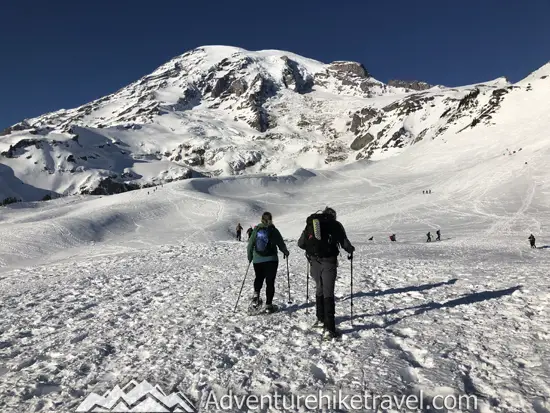 New to snowshoeing? Are you a local living in Washington State or visiting the Pacific Northwest during winter? Want something fun to do? Try snowshoeing at Mt. Rainier National Park.Our First-timer’s Guide to Snowshoeing at Mt. Rainier can give you the information you need to take off on your own snowshoeing adventure. #hiking #nature #mountains #adventure #travel #Mtrainier #traveltips #experiencewa #snowshoeing #pacificnorthwest #wastate #nationalparks #ustravel