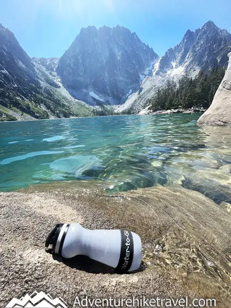 Stay healthy while traveling! Get a reliable Water-to-Go filter bottle for clean water on hikes and adventures. Don't risk getting sick from waterborne bacteria or parasites like Giardia. Read our gear review in the blog post.