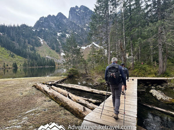 Hike to Heather Lake in Washington for a scenic 4.7-mile trail featuring old-growth forest, waterfalls, wildflowers, and a peaceful alpine lake in the North Cascades.