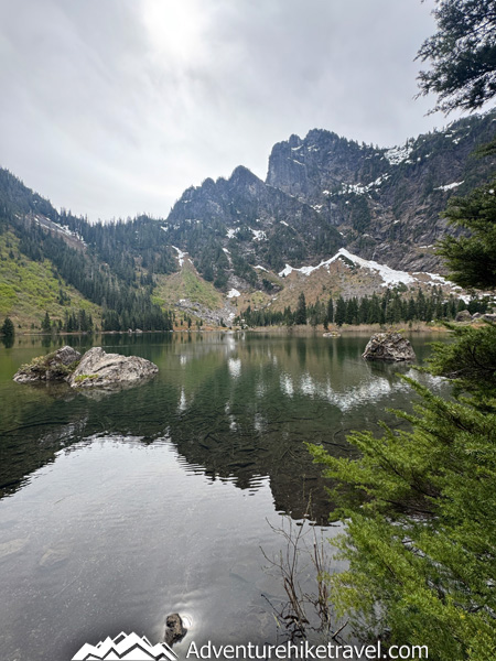 Hike to Heather Lake in Washington for a scenic 4.7-mile trail featuring old-growth forest, waterfalls, wildflowers, and a peaceful alpine lake in the North Cascades.