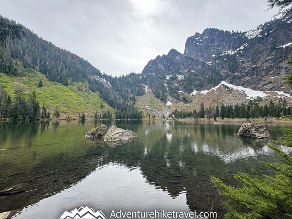 Hike to Heather Lake in Washington for a scenic 4.7-mile trail featuring old-growth forest, waterfalls, wildflowers, and a peaceful alpine lake in the North Cascades.