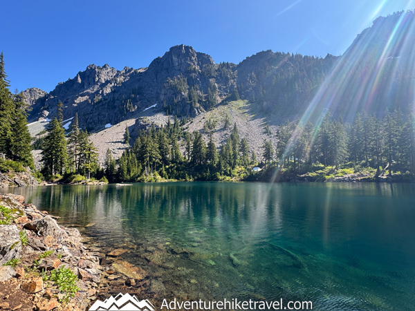 Experience the beauty of Melakwa Lake in the Alpine Lakes Wilderness! Hike through forests, past waterfalls, a rock waterslide, and rugged terrain to reach a stunning turquoise alpine lake framed by dramatic peaks. A must-do challenging day hike near Snoqualmie Pass! #MelakwaLakeHike