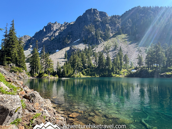 If you’re searching for an unforgettable day hike near Snoqualmie Pass, Melakwa Lake is it! This Alpine Lakes Wilderness trail offers lush forests, rushing rivers, waterfalls, a natural rock waterslide, rugged terrain, and a jaw-dropping turquoise alpine lake framed by dramatic peaks. #MelakwaLakeHike