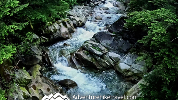 Plan your hike to Melakwa Lake, Washington, along the scenic Denny Creek Trail. Enjoy mossy forests, river crossings, wildflowers, and a turquoise alpine lake framed by peaks. A must-do PNW day hike for experienced hikers and outdoor enthusiasts. #MelakwaLake