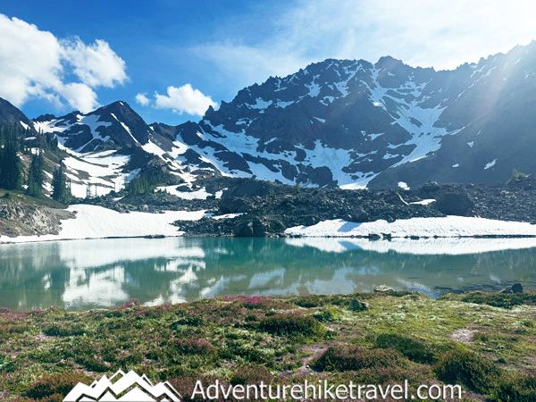 Royal Lake and Upper Royal Basin are a backpacker’s dream in Olympic National Park. This trail passes towering firs, rushing creeks, and colorful meadows before reaching turquoise alpine lakes with Mount Deception and Mount Mystery towering above. Learn about trail distance, elevation, camping permits, and tips for a safe, unforgettable hike.