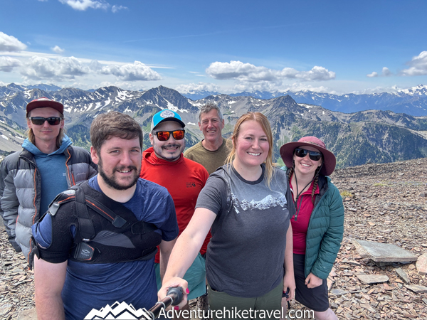 Hiking along the Moose Peak ridgeline in Olympic National Park with expansive views of alpine terrain, rocky slopes, and surrounding mountain ranges