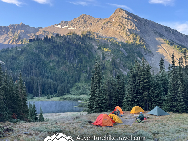 Backcountry backpacking campsite at Moose Lake featuring open alpine surroundings, nearby water access, and mountain views in Olympic National Park