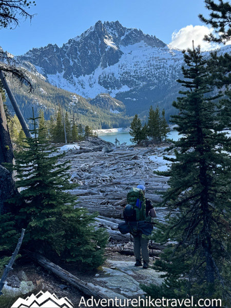 Spring conditions in the Enchantments can change quickly. This post shares our Snow Lakes Trail to Core Zone backpacking trip in mid-May, including trail info, elevation gain, distance, snow conditions, navigation, gear, frozen lakes, and what to expect during early season backpacking near Leavenworth, WA.