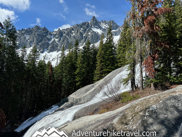Spring conditions in the Enchantments can change quickly. This post shares our Snow Lakes Trail to Core Zone backpacking trip in mid-May, including trail info, elevation gain, distance, snow conditions, navigation, gear, frozen lakes, and what to expect during early season backpacking near Leavenworth, WA.